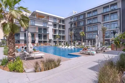 an apartment complex with a swimming pool and palm trees at New Listing * Pool & Marina Skyline View * TOP Amenities in Dubai