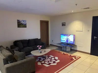a living room with a couch and a tv at luxury master room available in sulafa tower marina in Dubai