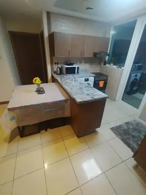a kitchen with a counter and a table in it at luxury master room available in sulafa tower marina in Dubai