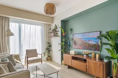 a living room with a couch and a tv at The Star in Dubai