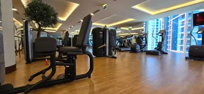 a gym with treadmills and ellipticals in a building at The Star in Dubai