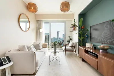 a living room with a couch and a tv at The Star in Dubai