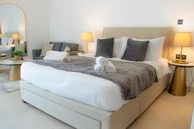 a large white bed with two stuffed animals on it at Dubai Skyline Retreat with Burj Khalifa View in Dubai