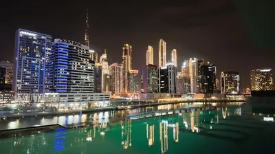 a view of a city skyline at night at Dubai Skyline Retreat with Burj Khalifa View in Dubai