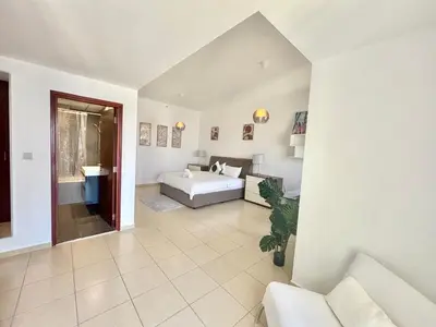 a large bedroom with a bed and a couch at Spacious Full Sea View Full Apartment in Dubai