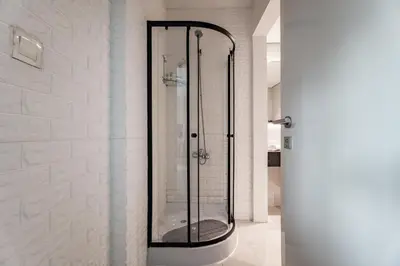 a shower with a glass door in a bathroom at GuestReady - Maison Vogue Studio Business Bay in Dubai