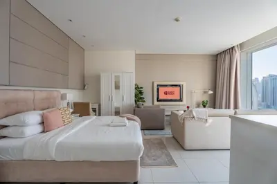 a bedroom with a large bed and a couch at GuestReady - Maison Vogue Studio Business Bay in Dubai