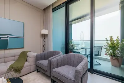 a living room with a couch and two chairs at Beachfront Bliss 2BR Dubai Eye & Full Sea View at the Address Beach By ĀYA Boutique in Dubai