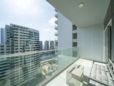 an apartment balcony with a view of a city at 1 Bedroom Business Bay Bliss with a Canal View in Dubai