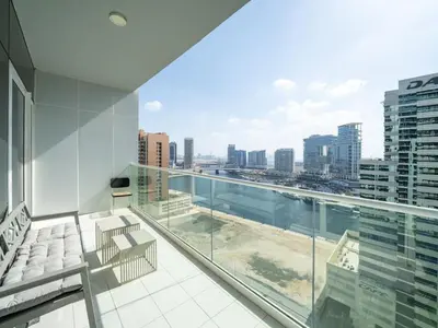 an apartment balcony with a view of the city at 1 Bedroom Business Bay Bliss with a Canal View in Dubai