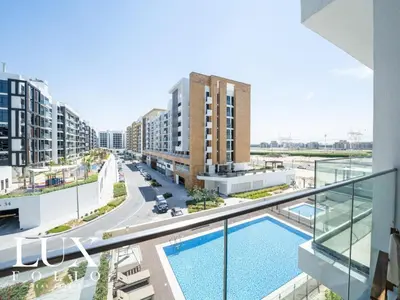 an image of an apartment complex with a swimming pool at Chic 1 Bed Meydan Escape with a Pool View in Dubai