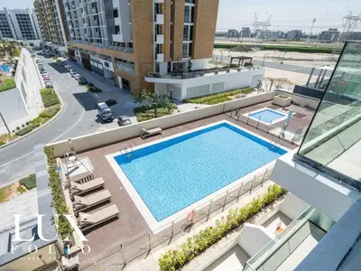 an overhead view of a swimming pool on a building at Chic 1 Bed Meydan Escape with a Pool View in Dubai
