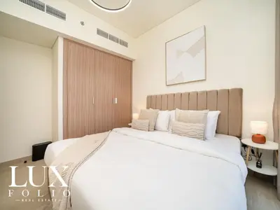 a bedroom with a large white bed in a room at Chic 1 Bed Meydan Escape with a Pool View in Dubai