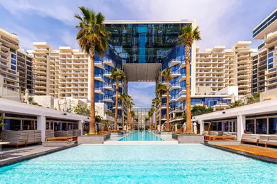 a swimming pool in the middle of a city with tall buildings at FIVE Palm Luxury 1BR Apartment with Stunning Views in Dubai