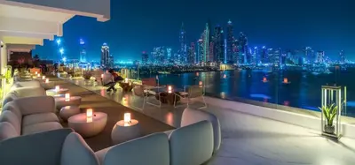a view of a city skyline from a balcony with candles at FIVE Palm Luxury 1BR Apartment with Stunning Views in Dubai