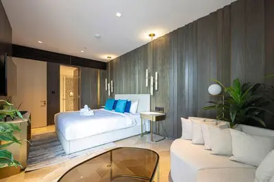 a bedroom with a white bed and a couch at FIVE Palm Luxury 1BR Apartment with Stunning Views in Dubai