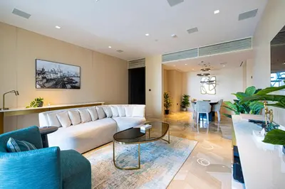 a living room with a white couch and a table at FIVE Palm Luxury 1BR Apartment with Stunning Views in Dubai