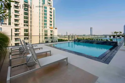a swimming pool on the roof of a building at Mira Holiday Homes - Lovely serviced apartment with pool access in Dubai