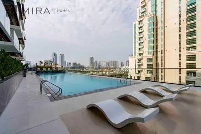 a swimming pool in the middle of a city with buildings at Mira Holiday Homes - Lovely serviced apartment with pool access in Dubai