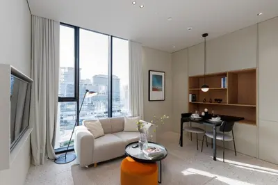 a living room with a couch and a table with a desk at Upside Living, Burj Khalifa View, Business Bay - Mint Stay in Dubai