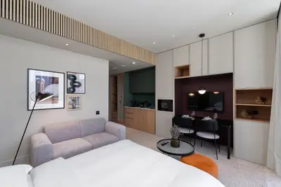 a bedroom with a bed and a living room at Upside Living, Burj Khalifa View, Business Bay - Mint Stay in Dubai