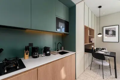 a kitchen with a counter with a table and a chair at Upside Living, Burj Khalifa View, Business Bay - Mint Stay in Dubai