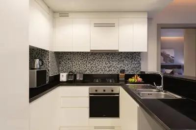 a kitchen with white cabinets and a sink at Aykon City Staycae Holiday Homes, Business Bay, Sheikh Zayed Road in Dubai