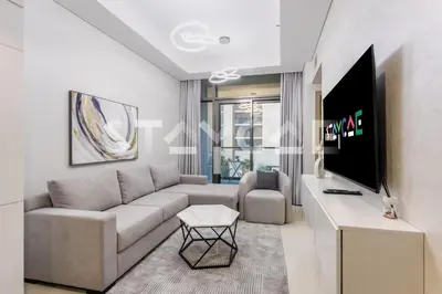 a living room with a couch and a tv at Aykon City Staycae Holiday Homes, Business Bay, Sheikh Zayed Road in Dubai