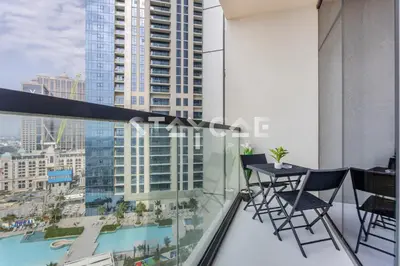 a balcony with a table and chairs on a building at Aykon City Staycae Holiday Homes, Business Bay, Sheikh Zayed Road in Dubai