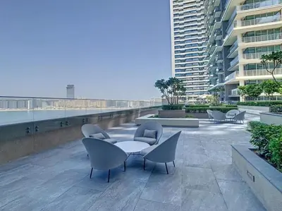 a patio with chairs and a table on a building at Modern 1BR Oasis in Beach Isle with Beach Access in Dubai