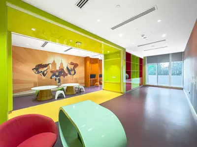 a brightly colored room with a table and chairs at Escape24 Stylish 2BR Apartment at Damac Maison Privé, Business Bay with Canal View in Dubai