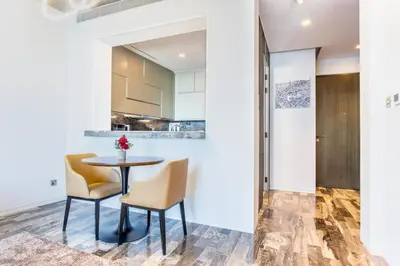 a kitchen and dining room with a table and chairs at Damac Heights by Fendi in Dubai