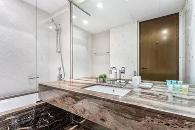 a bathroom with a sink and a shower at Damac Heights by Fendi in Dubai