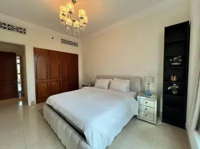 a bedroom with a large white bed and a chandelier at Lux Souk al Bahar Downtown Dubai 1 bedroom flat - Steps to Dubai Mall in Dubai