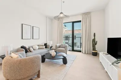 a living room with a couch and a table at The Smart Concierge - La Rive Port De Lamer in Dubai