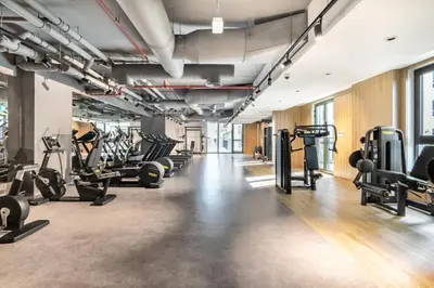 a gym with treadmills and cardio machines at The Smart Concierge - La Rive Port De Lamer in Dubai