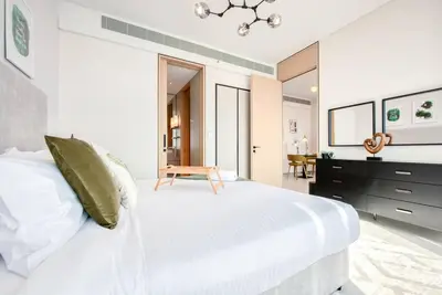 a bedroom with a large white bed and a desk at 1BR Apartment at The Address JBR - Residential in Dubai