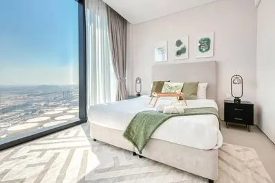 a bedroom with a large bed and a large window at 1BR Apartment at The Address JBR - Residential in Dubai