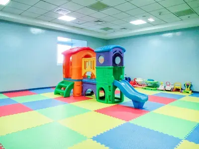 a childrens play room with a playground with a slide at The Smart Concierge - Elite residence in Dubai