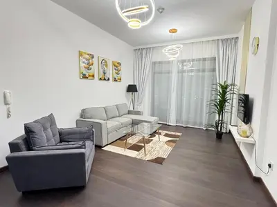 a living room with a couch and a chair at Stay in the heart of Sport City in LUX 1BDR with sky view 11 in Dubai