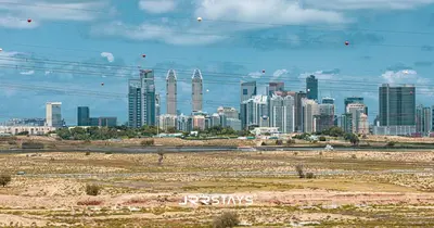 a city skyline with tall buildings in the distance at Sophisticated Studio JVC - Breathtaking City View in Dubai