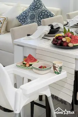 a white table with a plate of fruit on it at Marina & Beach Views, Pool, Art Haven! Near Cafes in Dubai