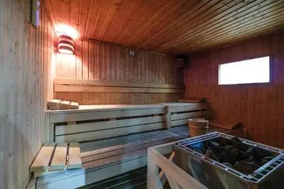a sauna with wooden walls and a window and benches at Marina & Beach Views, Pool, Art Haven! Near Cafes in Dubai