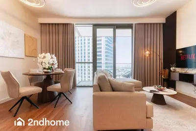a living room with a couch and a table at 2ndHome - Downtown Views 1 - Downtown Dubai in Dubai