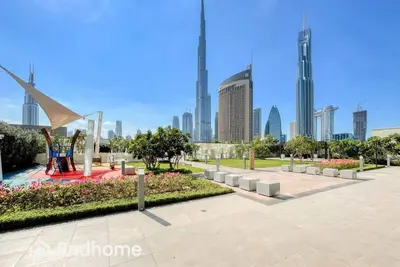a park in a city with tall buildings at 2ndHome - Downtown Views 1 - Downtown Dubai in Dubai
