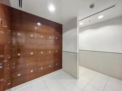 a locker room with wooden doors and a tile floor at FIRST CLASS 2BR Incredible Burj Khalifa View in Dubai