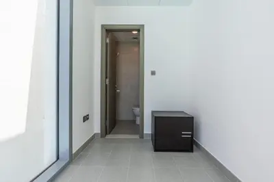 a hallway with a bathroom with a sink and a toilet at Serene and sophisticated Lagoon Living - Suiteable in Dubai