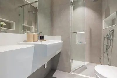 a bathroom with a sink and a shower at Serene and sophisticated Lagoon Living - Suiteable in Dubai