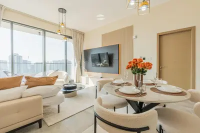 a living room with a couch and a table and chairs at Every Sunset is a Masterpiece in Catch Residence in Dubai