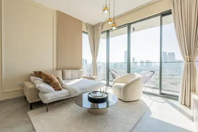 a living room with a couch and a table at Every Sunset is a Masterpiece in Catch Residence in Dubai